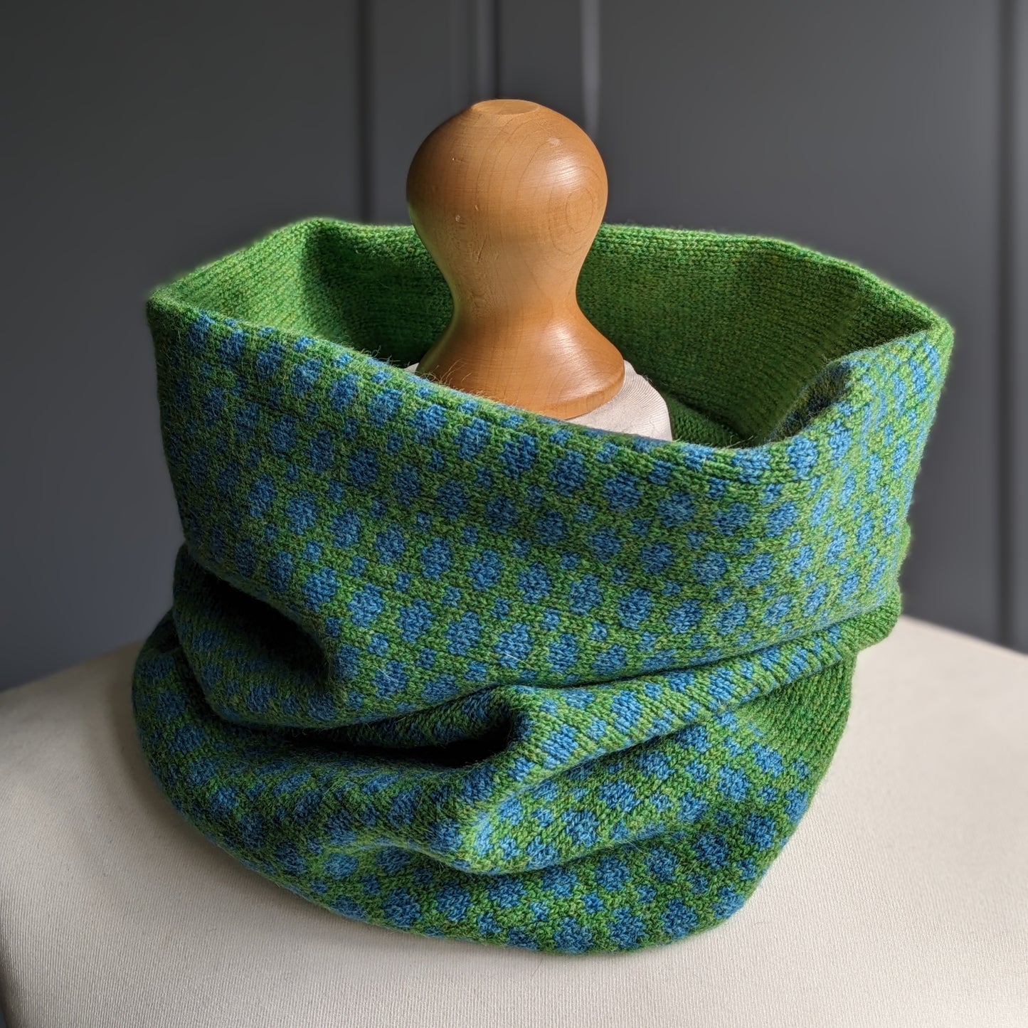 Lambswool knitted Fair Isle cowl in dots and spots design - grass and  petrol blue.