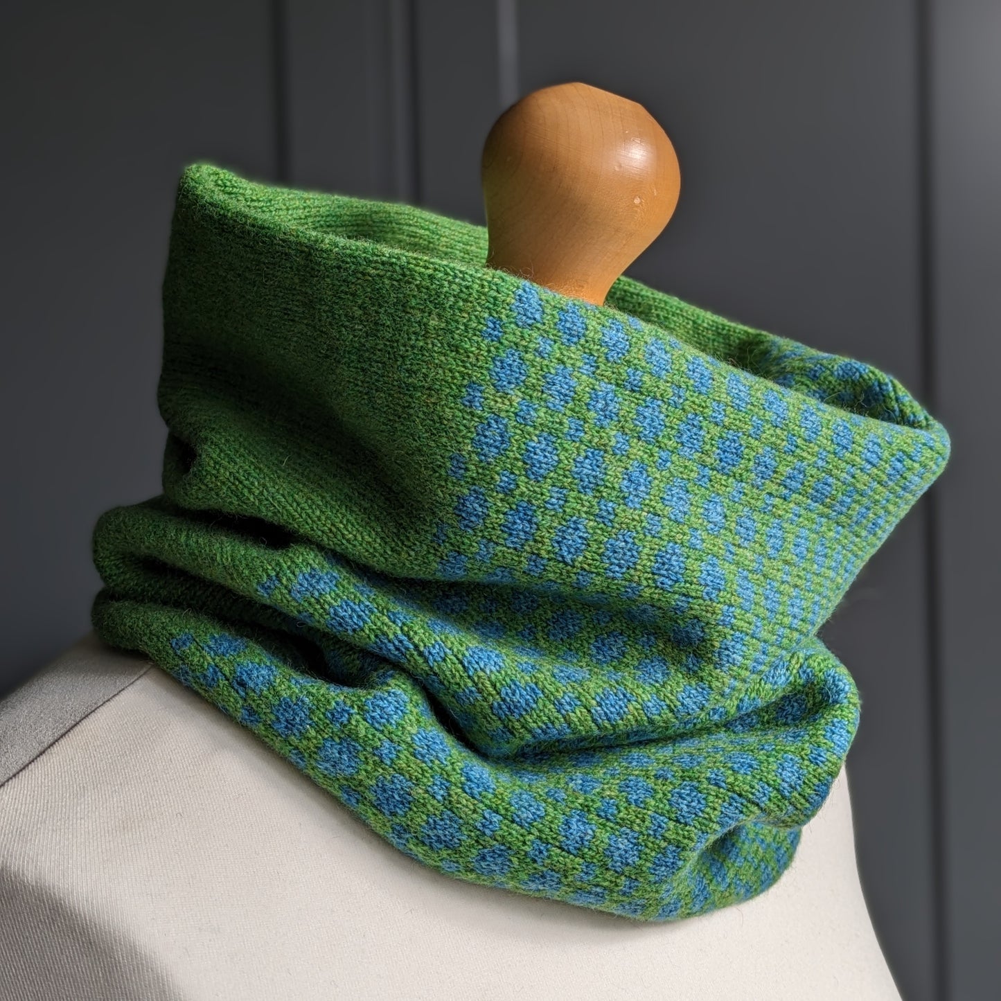 Lambswool knitted Fair Isle cowl in dots and spots design - grass and  petrol blue.