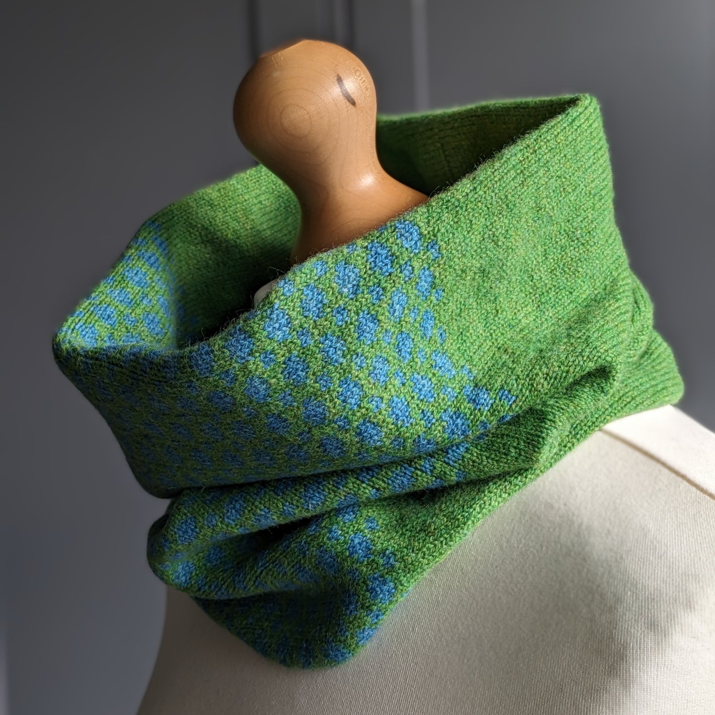 Lambswool knitted Fair Isle cowl in dots and spots design - grass and  petrol blue.