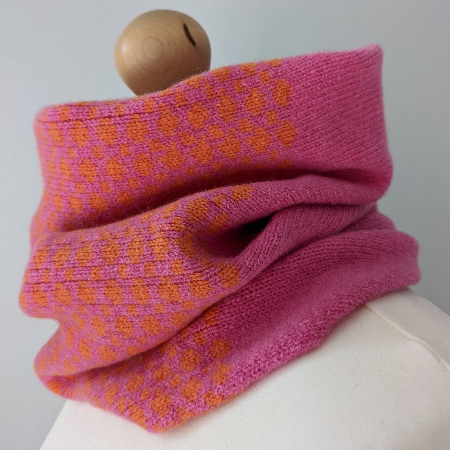 Lambswool knitted Fairisle cowl in dots and spots design - orange and pink