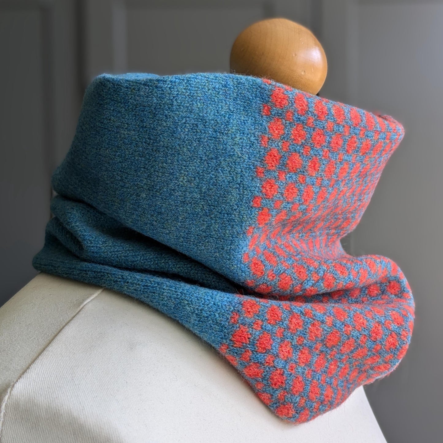 Lambswool knitted Fair Isle cowl in dots and spots design - blue with orange spots