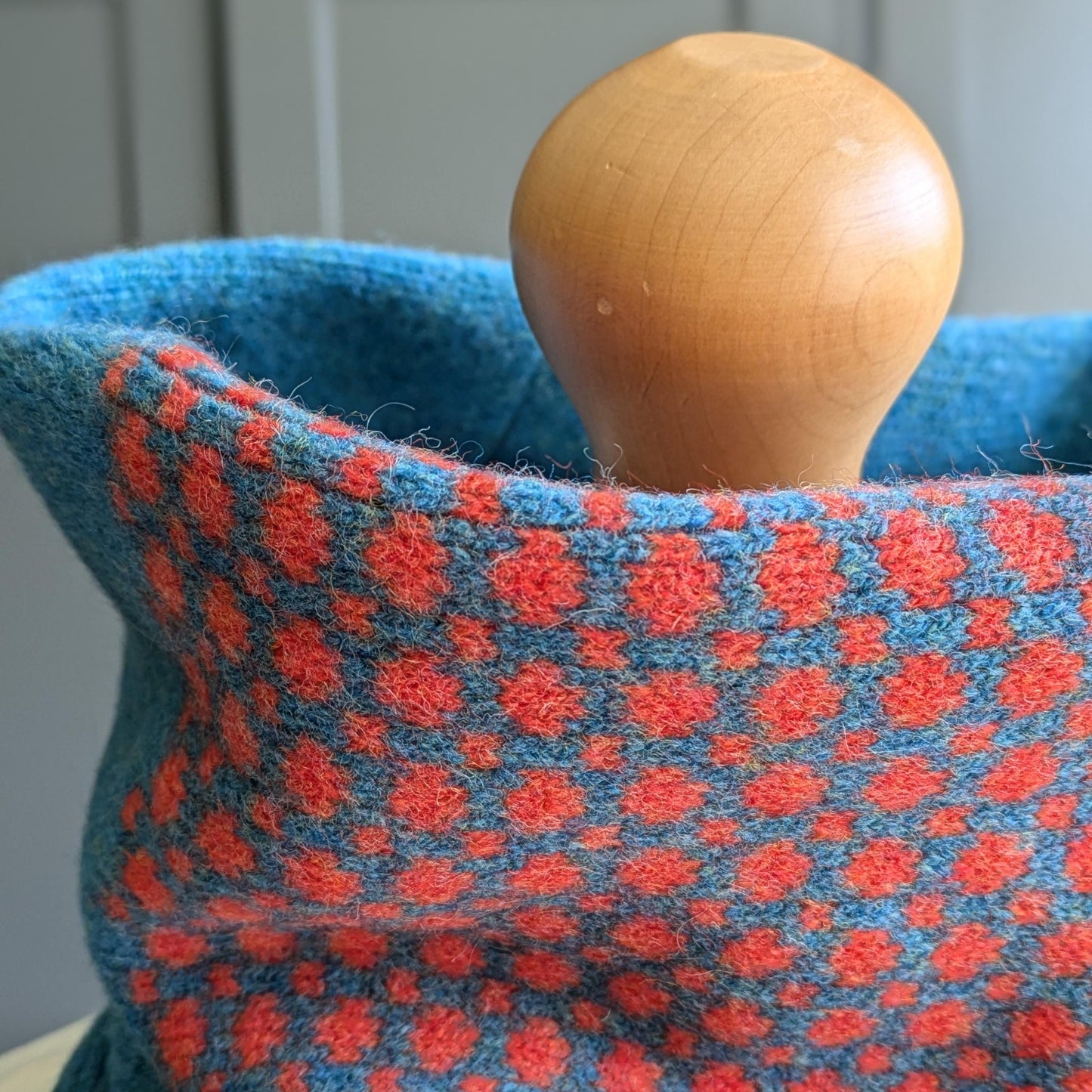 Lambswool knitted Fair Isle cowl in dots and spots design - blue with orange spots