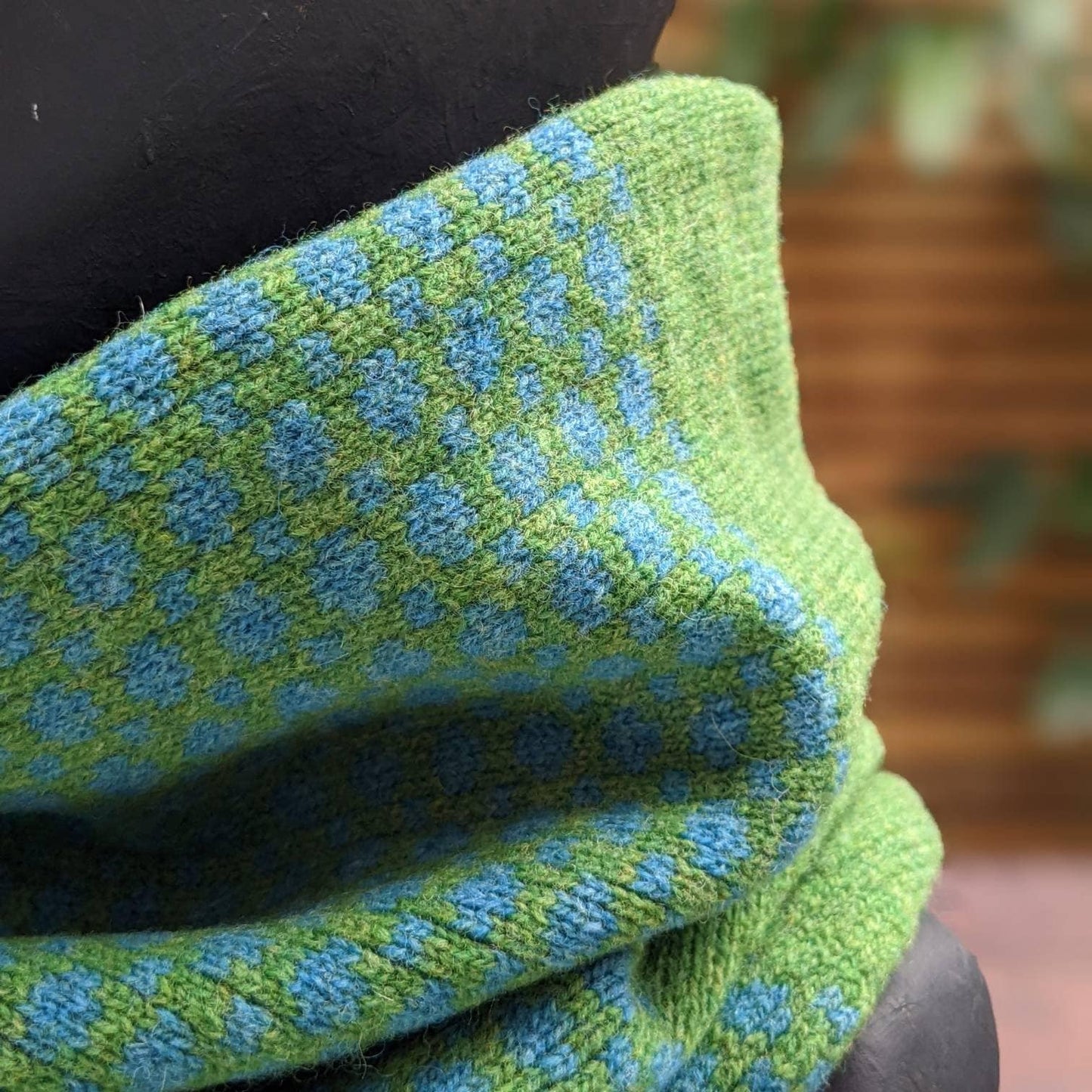 Lambswool knitted Fair Isle cowl in dots and spots design - grass and  petrol blue.