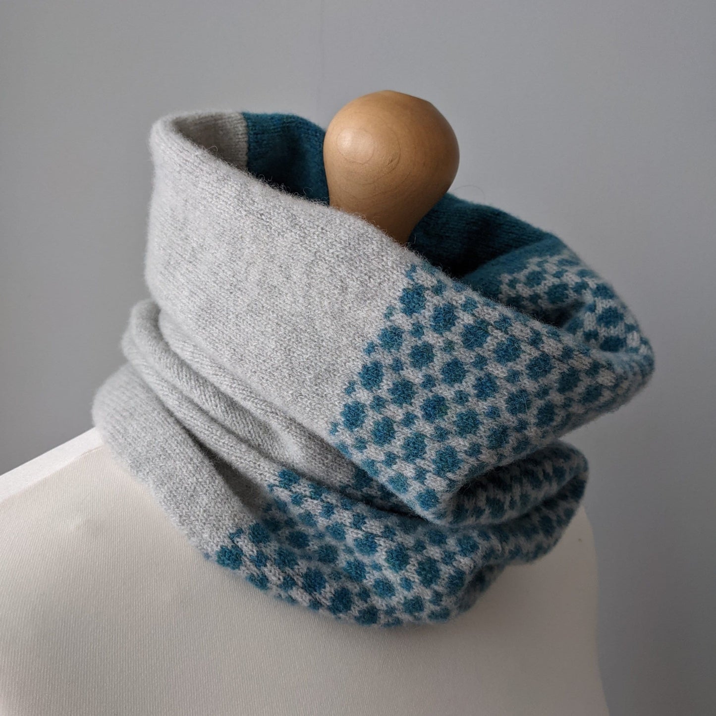 Lambswool knitted Fair Isle cowl in dots and spots design - pale grey and  petrol blue.