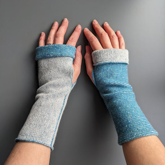 Knitted lambswool reversible wrist warmers in blue and pale grey