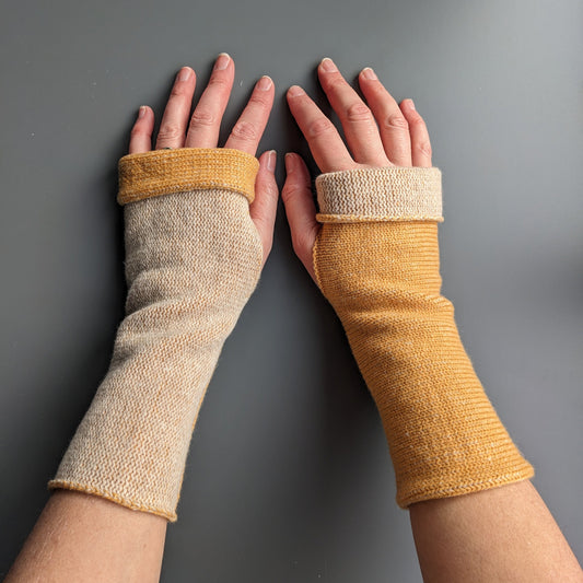 Knitted lambswool reversible wrist warmers in golden yellow and linen