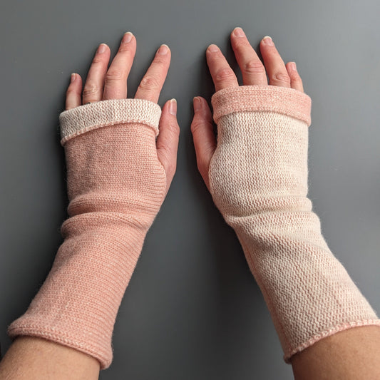 Knitted lambswool reversible wrist warmers in pastel pink and ecru