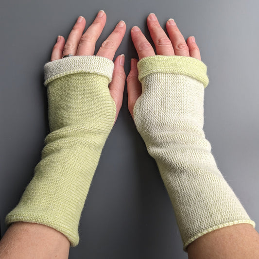 Knitted lambswool reversible wrist warmers in pastel green and ecru