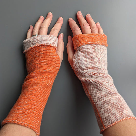 Knitted lambswool reversible wrist warmers in orange and pale grey